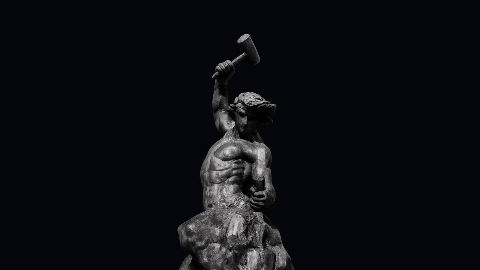 Statue of a man carving himself out of raw stone